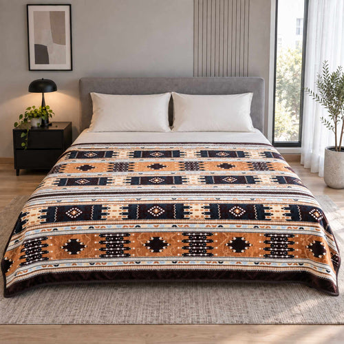 Camel / Cream Southwestern Geometric Stripe Cloudy Velvet Blanket displayed on a double bed