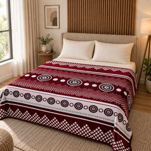 Burgundy / White Circular Geometric Stripe Cloudy Velvet Blanket displayed on a double bed