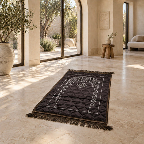 Dark Brown quilted velvet prayer mat (janamaz) with embroidered lattice mihrab on a stone floor