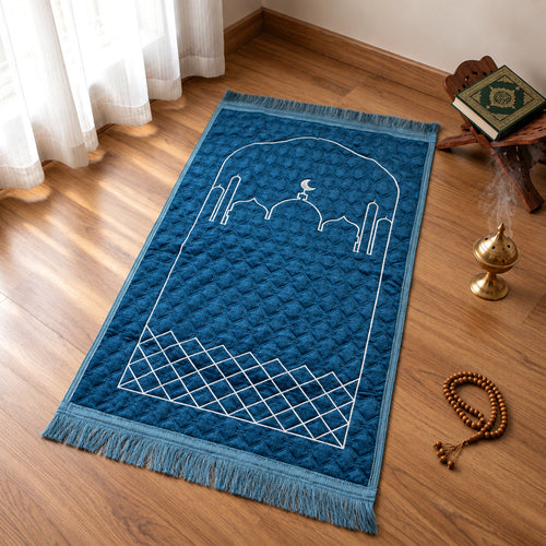 Royal Blue quilted velvet prayer mat (janamaz) with embroidered mosque design on a wooden floor