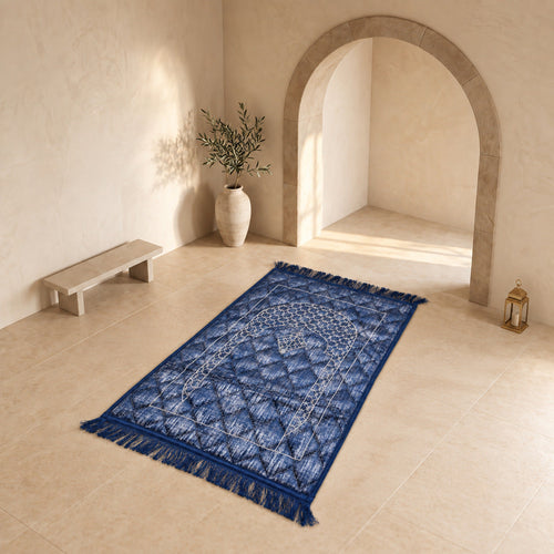 Royal Blue textured velvet prayer mat (janamaz) with embroidered lattice mihrab on a stone floor